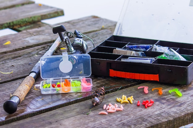 Many colorful lures for fishing on the wooden pier