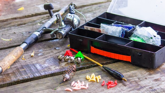 Many colorful lures for fishing on the wooden pier