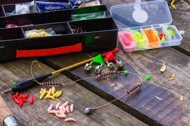 Many colorful lures for fishing on the wooden pier