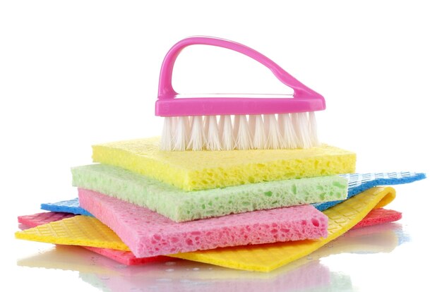 Many colorful sponges and brush for housework isolated on white