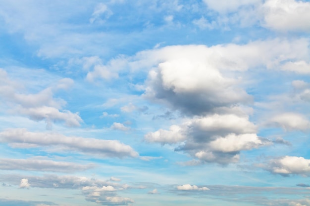 Many cumulus clouds in blue autumn sky