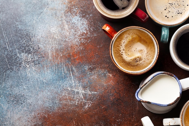 Many cups of coffee on stone table