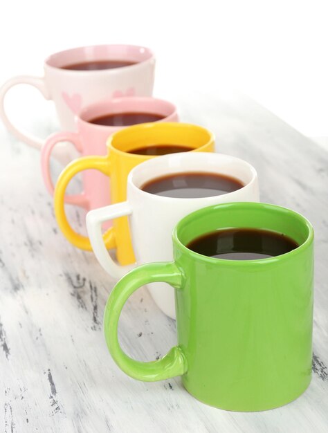 Many cups of coffee on wooden table close up