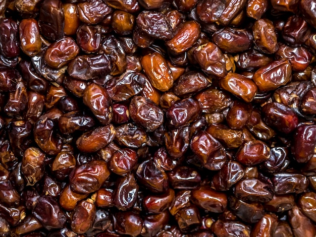 Many date fruits on the table background