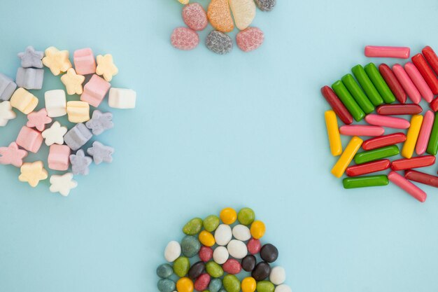 Many different candies sweets on blue background