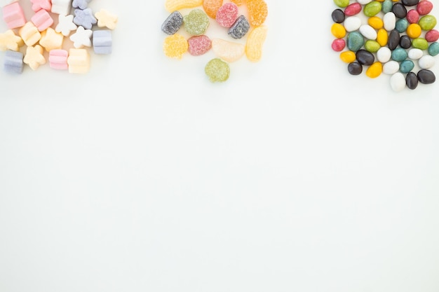 Many different candies sweets on white background