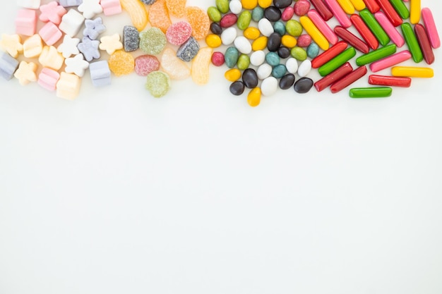 Many different candies sweets on white background