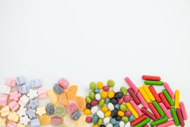 Many different candies sweets on white background