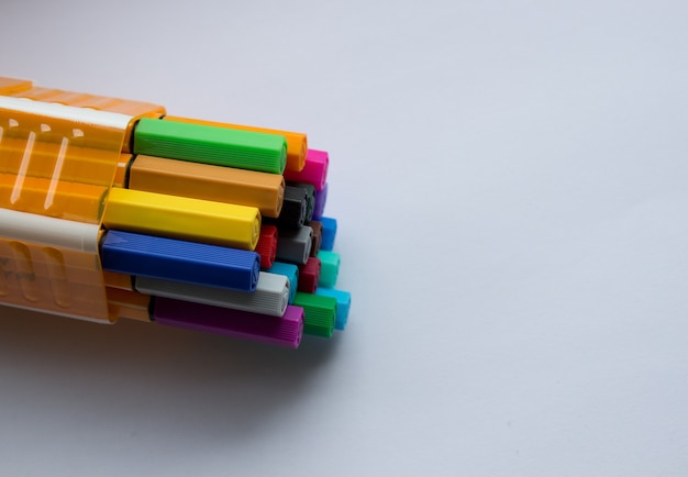 Many different colored pens. Color pencils isolated on a white background.