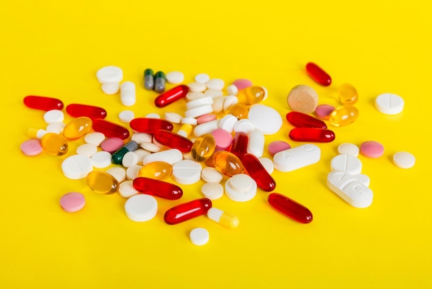 Many different colorful medication and pills perspective view Set of many pills on colored background