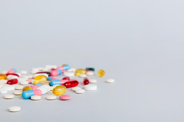 Many different colorful medication and pills perspective view Set of many pills on colored background