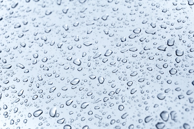 Many different drops of water on the metal surface