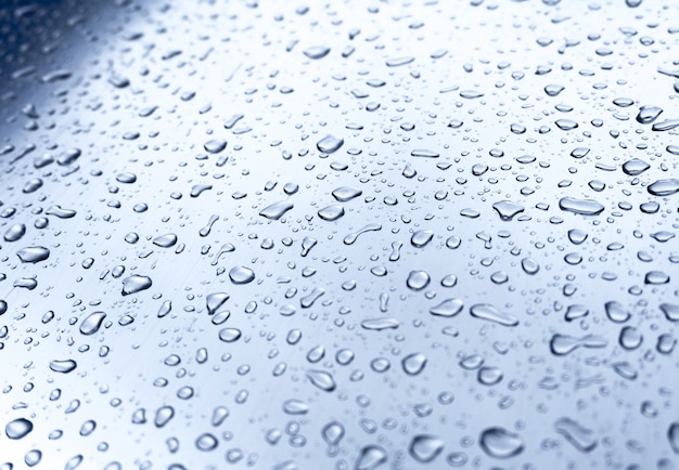 Many different drops of water on the metal surface