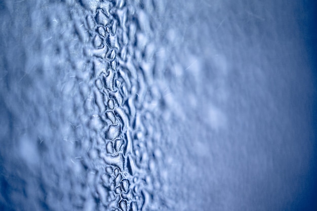 Many different drops of water on the metal surface