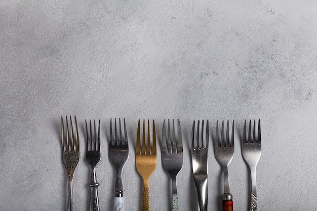 Many different forks on a light background