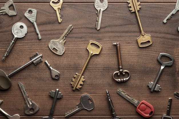 Many different keys on wooden table