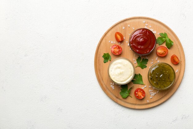 Many different sauces and herbs on table flat lay top view sauces on plate healthy concept