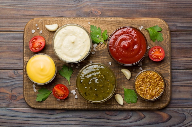 Many different sauces and herbs on table flat lay top view sauces on plate healthy concept