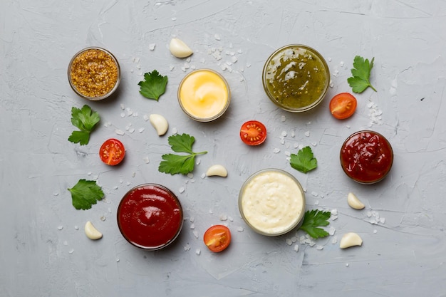 Many different sauces and herbs on table flat lay top view sauces with spices healthy concept