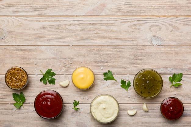 Many different sauces and herbs on table flat lay top view sauces with spices healthy concept