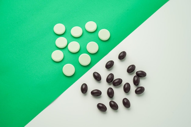 Many different tablet pills on color background, flat lay, with copy space.