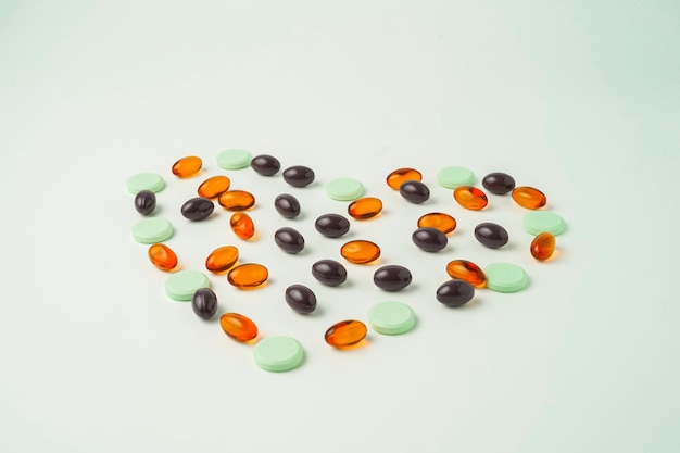 Many different tablet pills on white background, flat lay, with copy space.