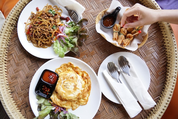 점심 시간에 손으로 음식을 가져가는 태국 북부의 나무 기구 종류에 대한 많은 요리.