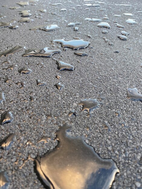 many drops of rain on the freshly laid asphalt