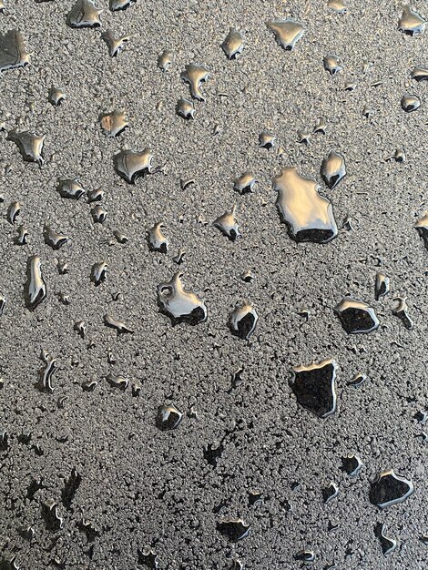 many drops of rain on the freshly laid asphalt