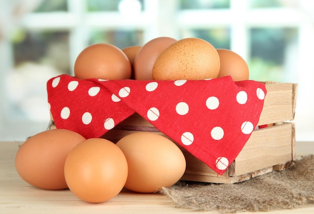 Many eggs in box on table in room