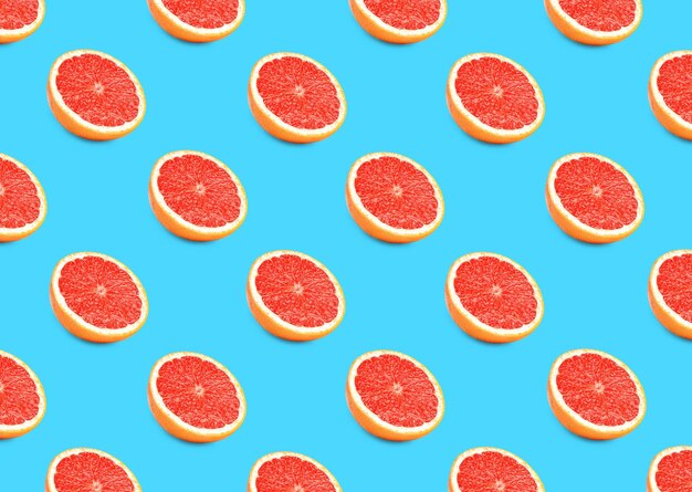 Photo many fresh ripe grapefruits on turquoise background seamless pattern design