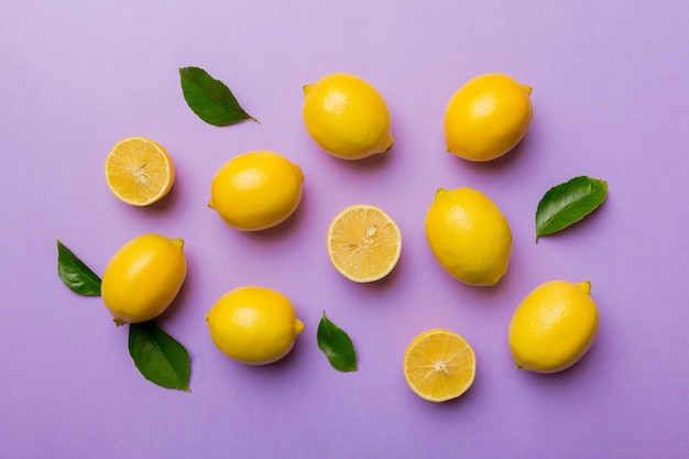 Many fresh ripe lemons as colored background top view Elegant background of lemon and lemon slices Top view flat lay