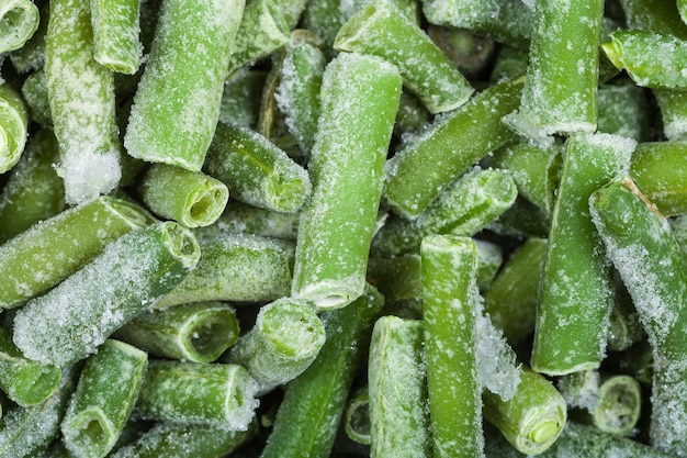 Many frozen cut green beans close up