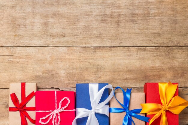 Many gift boxes on wooden background. Holiday concept