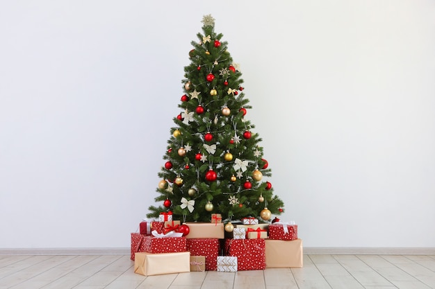 Many gifts under a festively decorated christmas tree in a bright interior