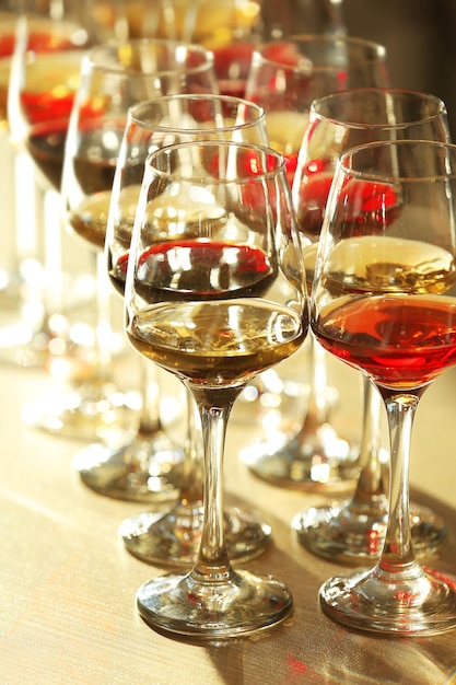 Many glasses of different wine in a row on a table