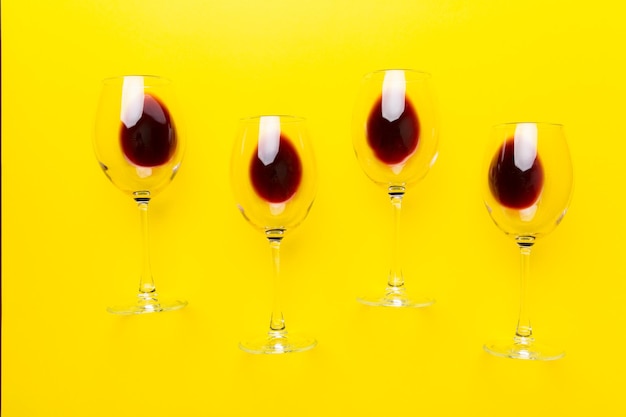 Many glasses of red wine at wine tasting concept of red wine on colored background top view flat lay design
