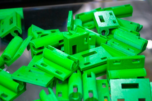 Many green details printed on d printer closeup parts d printed from molten plastic fdm technologies