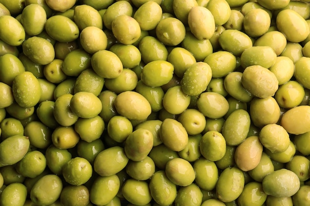 Many green olives as background