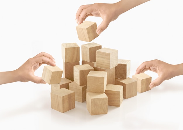 Many hands playing wooden box on isolated .