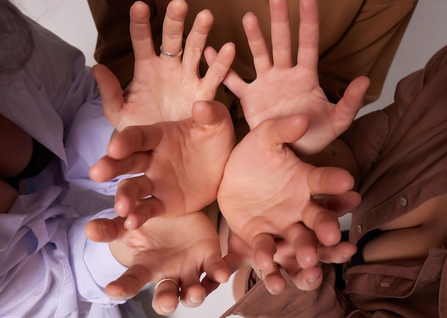 Many hands trying to reach and catch something