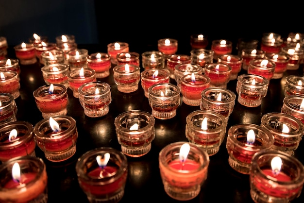 Many holiday burning candles in the dark