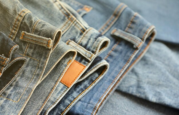 Many jeans in stack in wardrobe room row of pants denim jeans in closet concept of buy sell