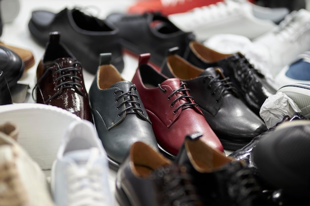 Many leather shoes in the store colorful leather shoes sneakers
closeup shot