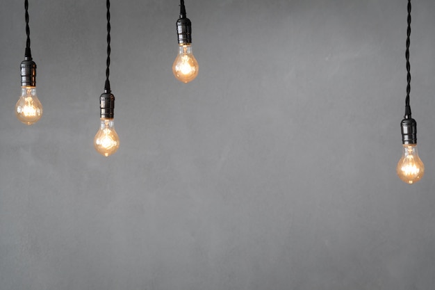 Many light bulbs against concrete wall surface