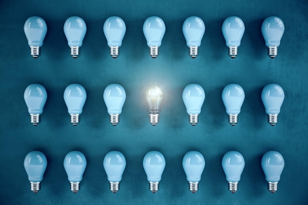 many light bulbs in a row and one glows