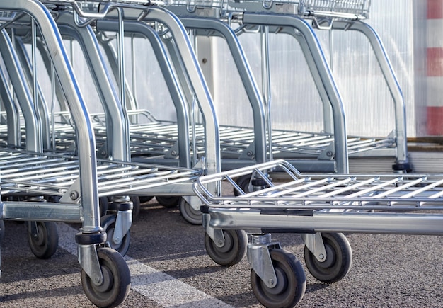 many lot of shopping cart trolley in market outside consumerism concept