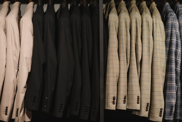 Many men's business suits of different colors