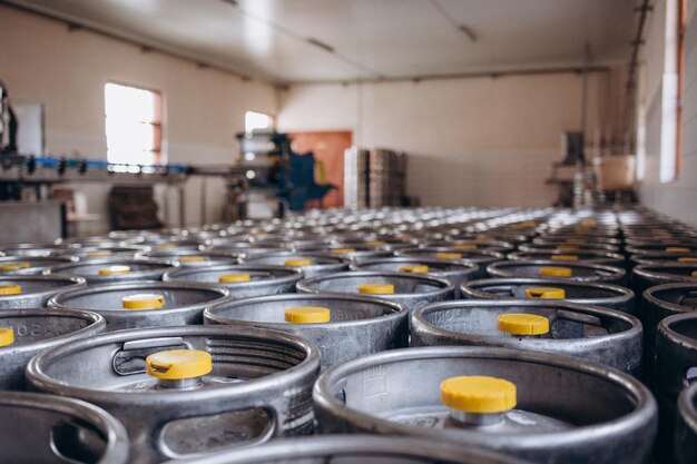 Many metal kegs of beer in regular rows