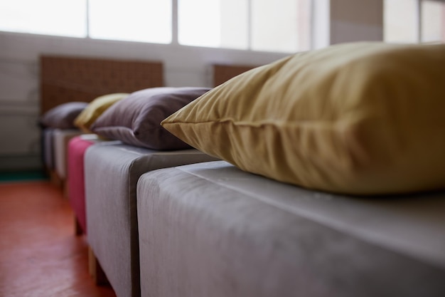 Many multicolored beds with pillows and linens in the interior of the gym